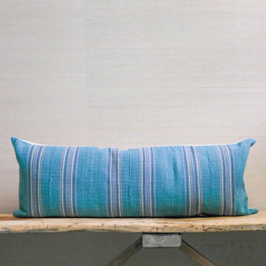 teal green base with orange, red and purple skinny stripes on handloomed textile bolster pillow