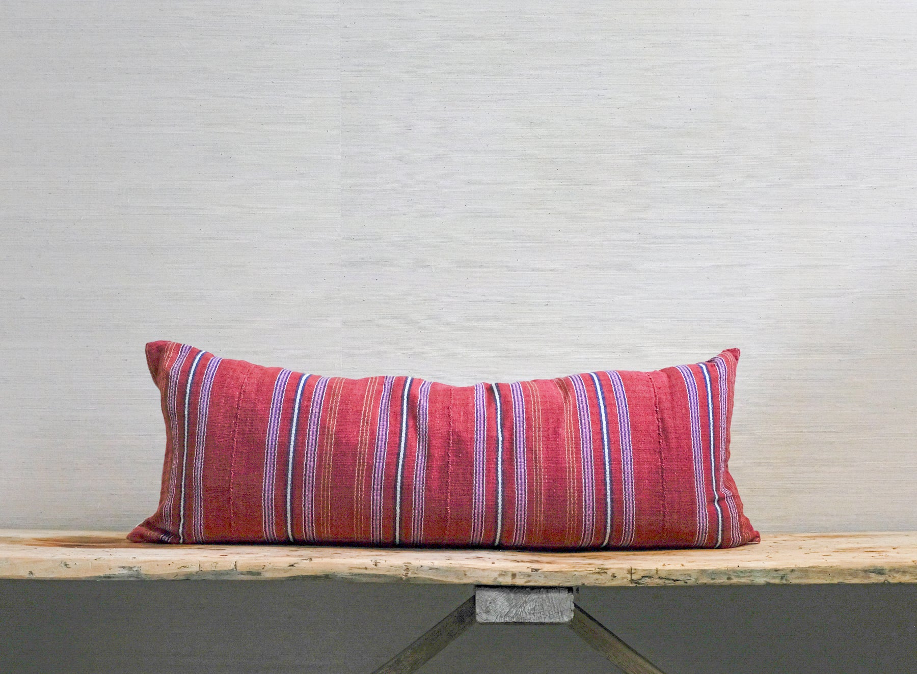 mostly red striped pillow, backstap loomed textile on front