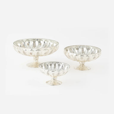 Set of three mercury glass pedestal bowls on a white background