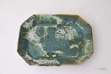 Decorative ceramic tray with a marbled green and blue design on a white background