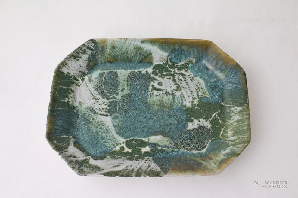 Decorative ceramic tray with a marbled green and blue design on a white background
