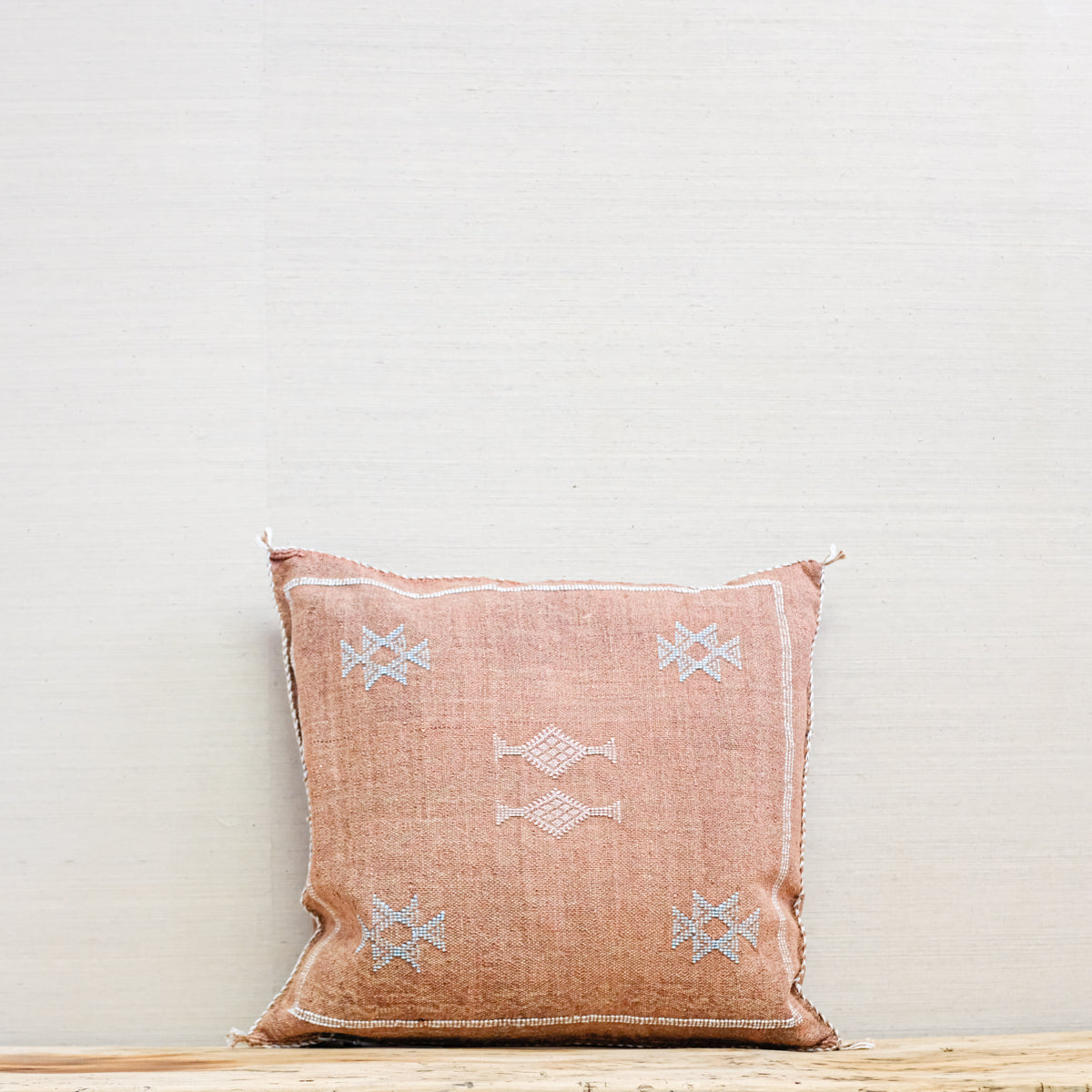 russet colored square pillow, woven with embroidery