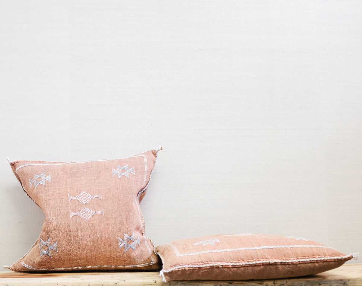 pair of square moroccan pillows in russet with pale blue embroidery