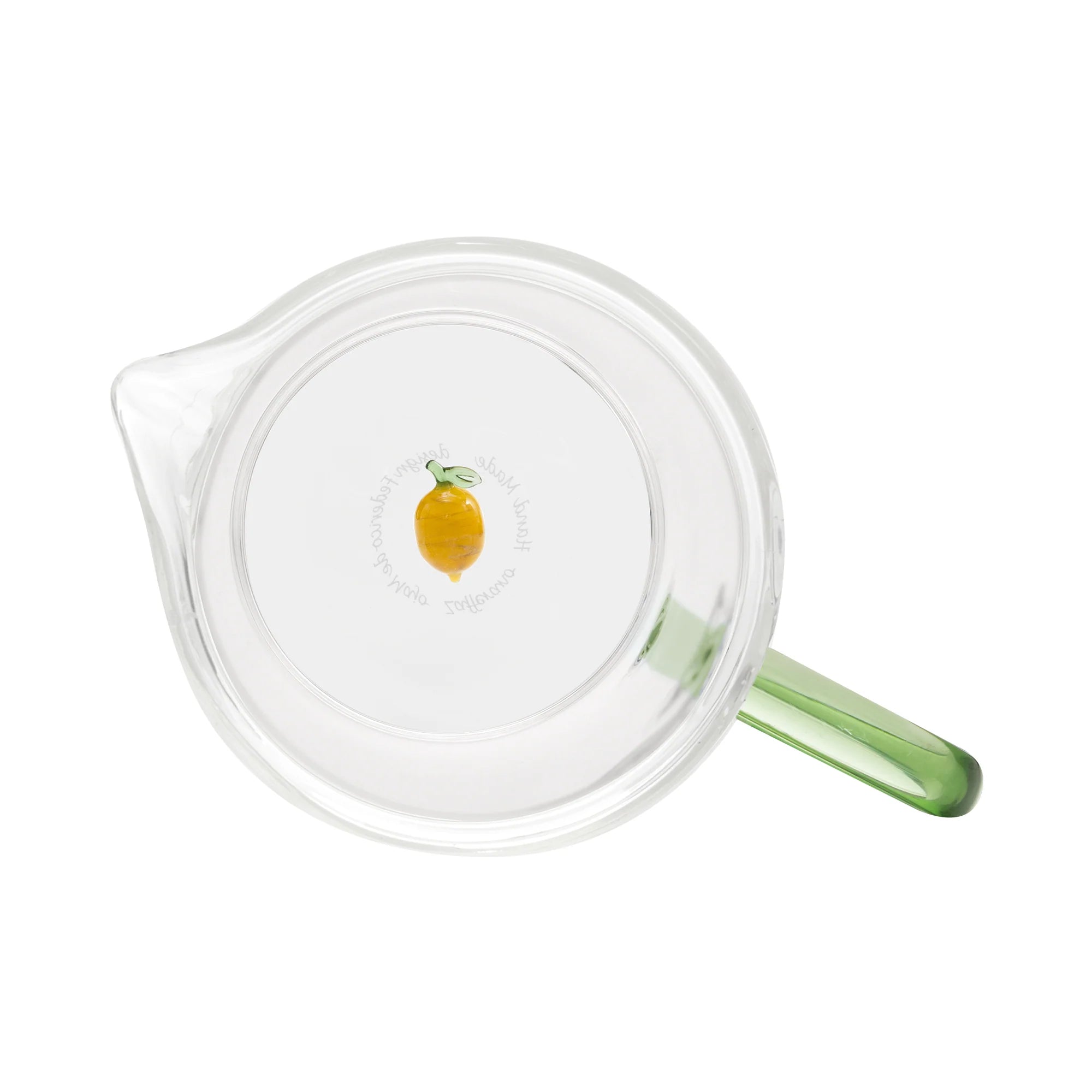 Clear glass carafe with a green handle on a white background