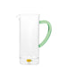 Clear glass pitcher with a green handle on a white background