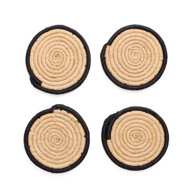 Four circular coasters with spiral pattern on a white background