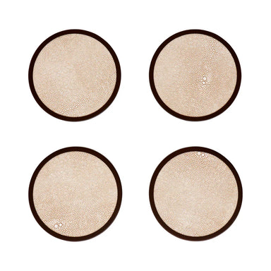 Four round beige coasters with brown rims on a white background