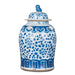 Blue and white ceramic jar with floral patterns on a white background