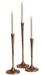 Three textured metallic gold candlestick holders with white taper candles, arranged on a seamless white background.