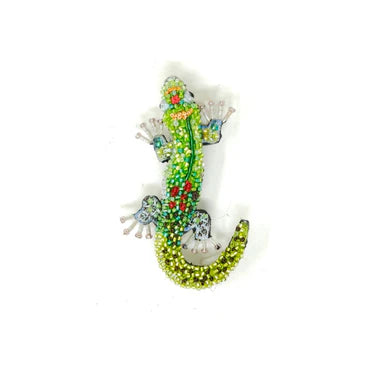 Decorative  gecko brooch with beads and crystals on a white background