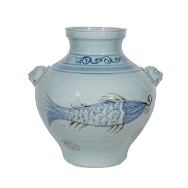 Ceramic vase with blue fish design on a white background