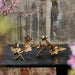 Bronze floral sculpture on a dark surface with a blurred natural background
