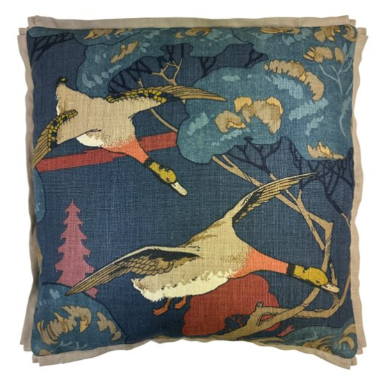 Decorative pillow with nature-themed design featuring ducks and trees on a blue background.