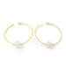 Gold hoop earrings with white spherical charms on a white background