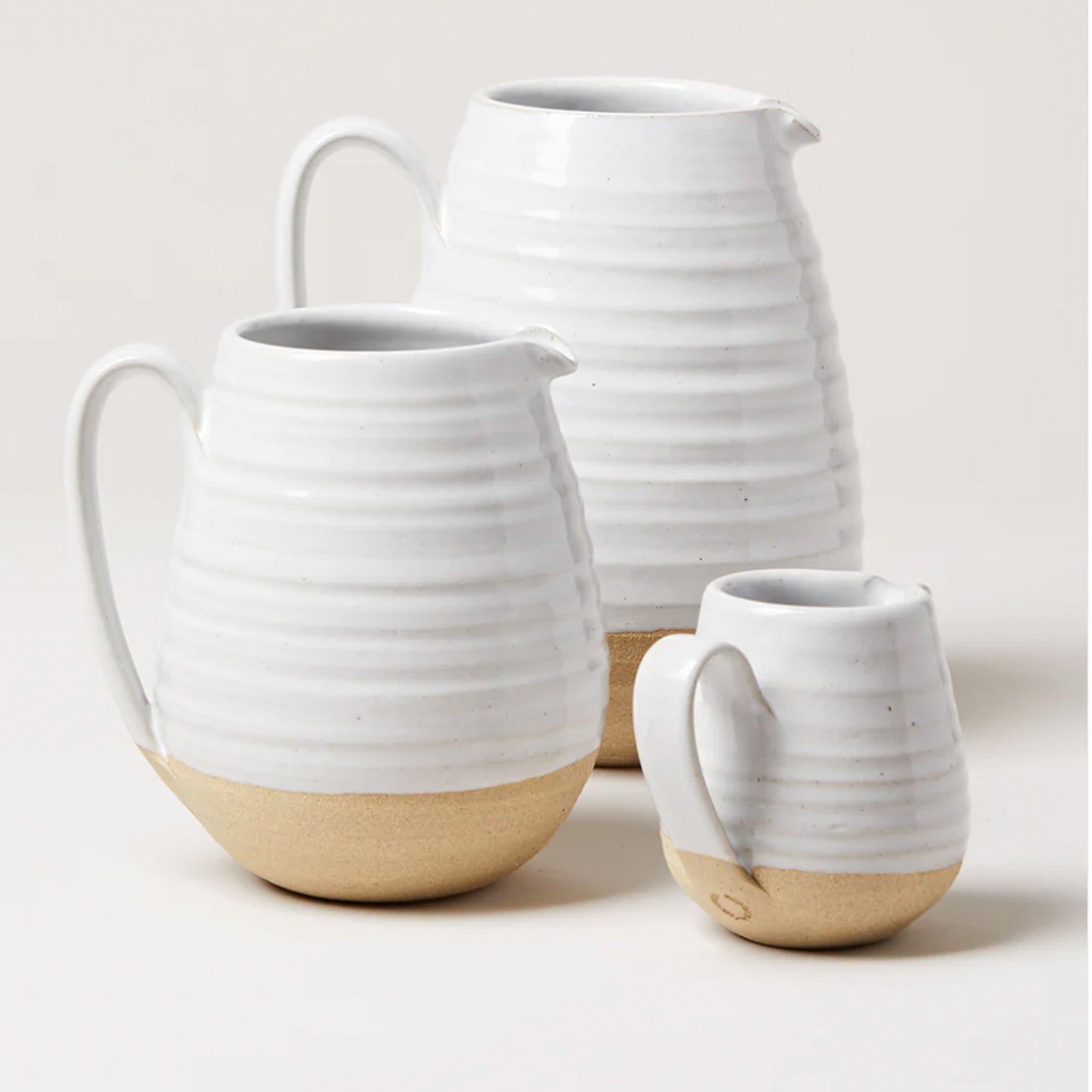 trio of pottery pitchers