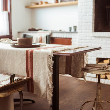 Dining table with a striped tablecloth in a cozy kitchen setting