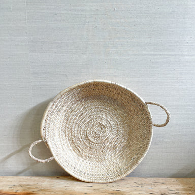 round flat woven grass basket with two handles