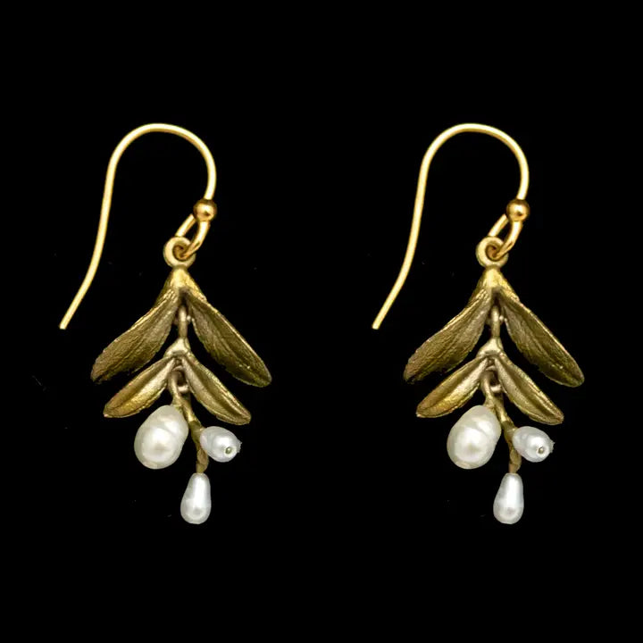 Gold leaf earrings with pearl drops on a black background