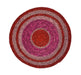 Round woven mat with concentric circular pattern in red and pink on a white background