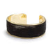 Gold and black hair-on-hide cuff bracelet on a white background