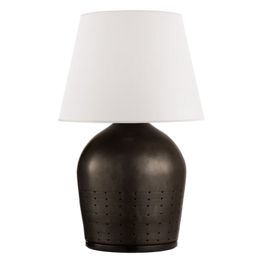 Table lamp with a textured brown base and white shade on a black background