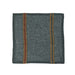 Gray linen napkin with red and yellow stripes on a white background