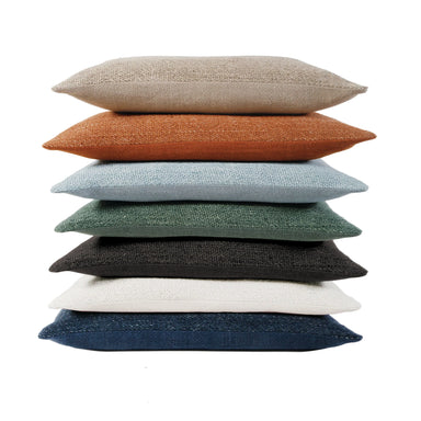 Stack of multicolored cushions on a white background