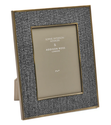 Herringbone patterned photo frame with gold trim on a white background