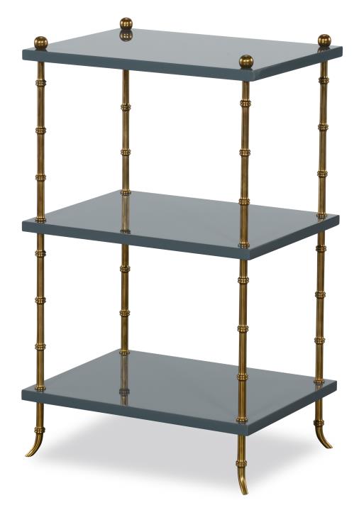 Three-tiered shelf with brass accents on a white background