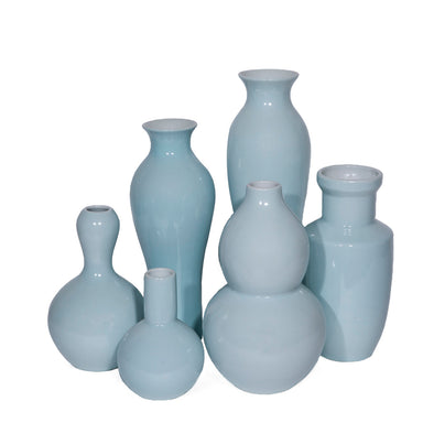Set of light blue ceramic vases on a white background