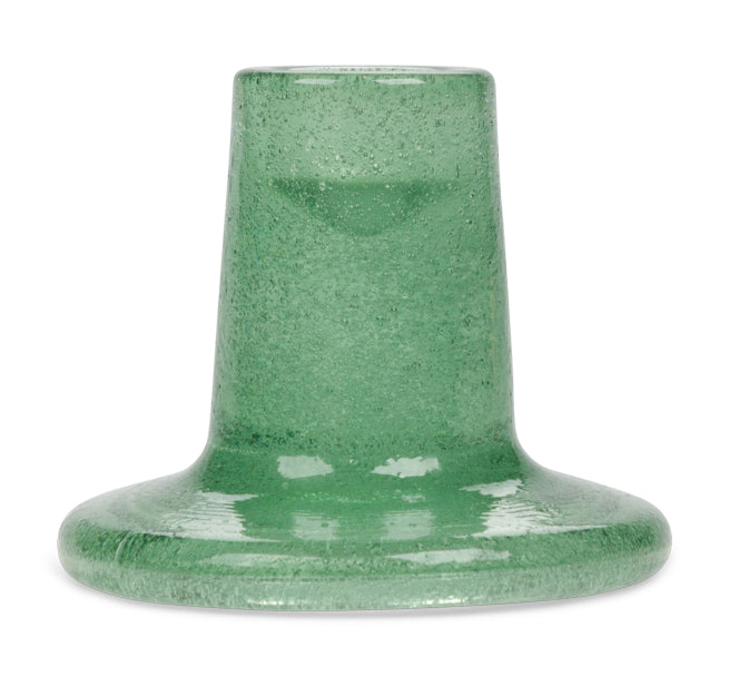 Green glass candleholder on a white background