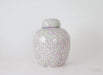Decorative ceramic jar with a floral pattern on a white background