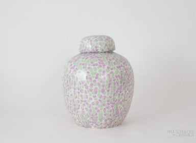 Decorative ceramic jar with a floral pattern on a white background