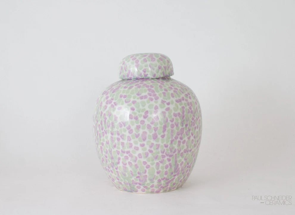 Decorative ceramic jar with a floral pattern on a white background