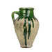 Vintage ceramic jar with green glaze on a white background