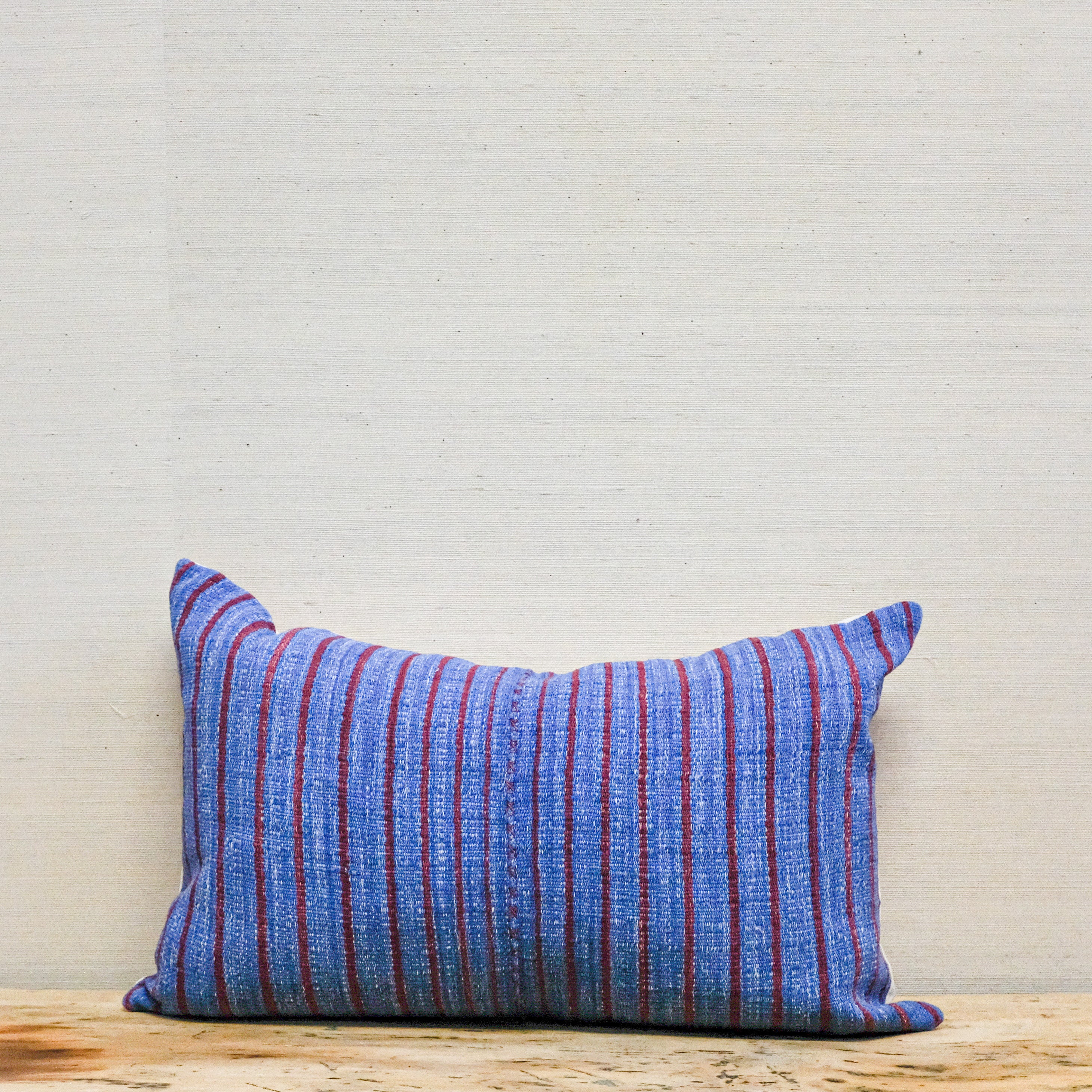 blue and red stripe handwoven textile on 14x22 pillow