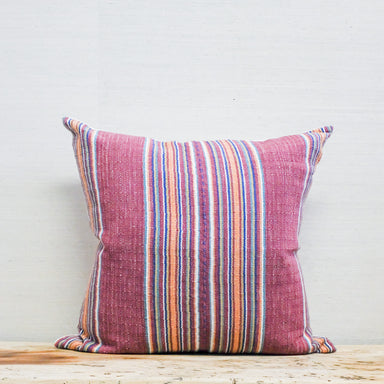 multi-color stripe textile on a square pillow