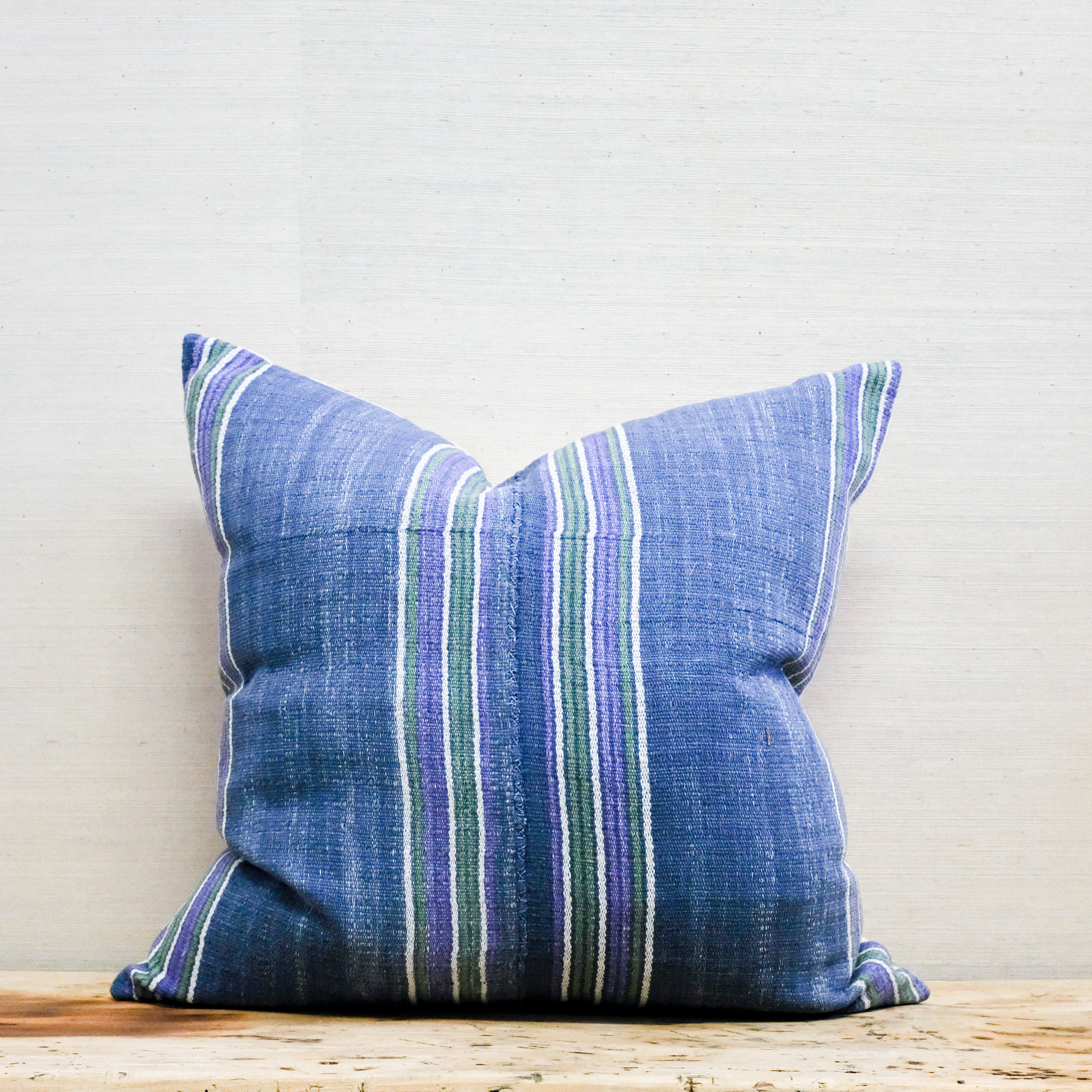 blue, green and purple stripe textile pillow