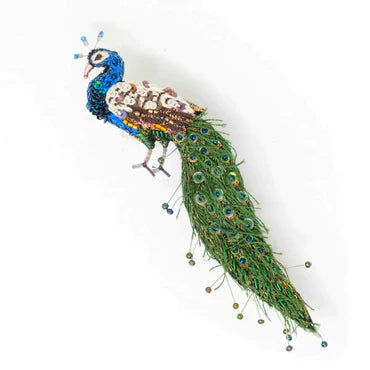Decorative peacock feather with beads on a white background