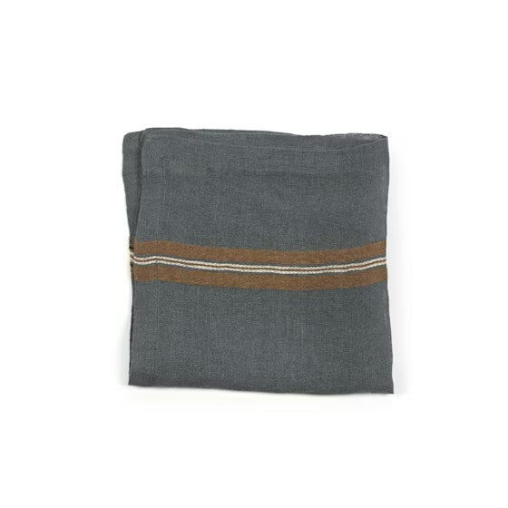 Folded gray linen napkin with brown and white stripes on a white background