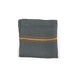 Folded gray linen napkin with brown and white stripes on a white background