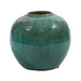 Green ceramic vase with textured design on a white background