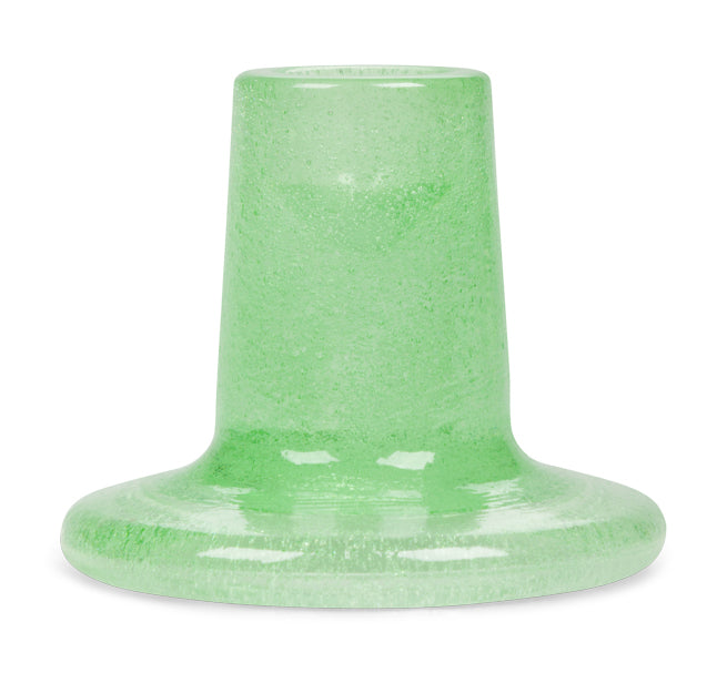 Green glass candleholder on a white background