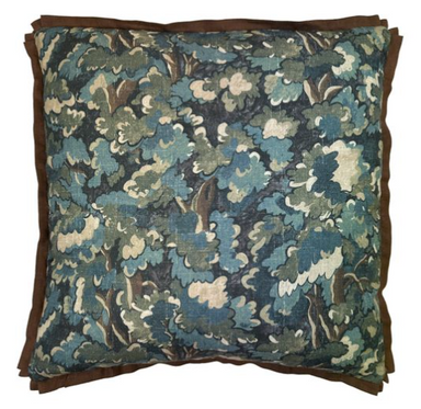 Floral patterned pillow with brown border on a white background