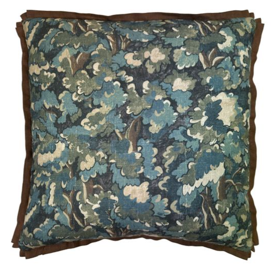 Floral patterned pillow with brown border on a white background