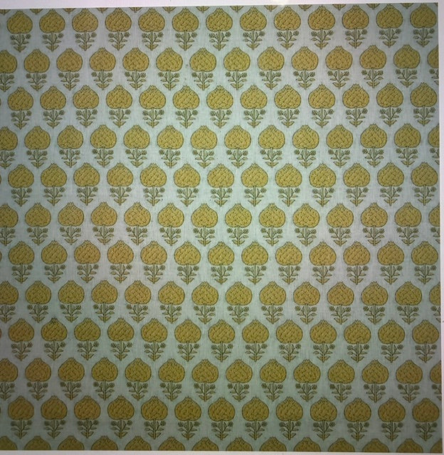 A close-up of a repeating fabric or wallpaper pattern featuring mustard yellow floral motifs on a light sage green background.