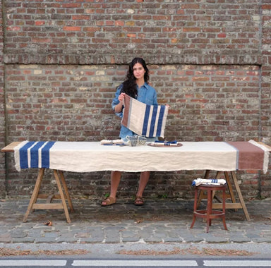 striped linen table cover in brick wall courtyard setting