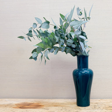 glossy green vase with eucalyptus