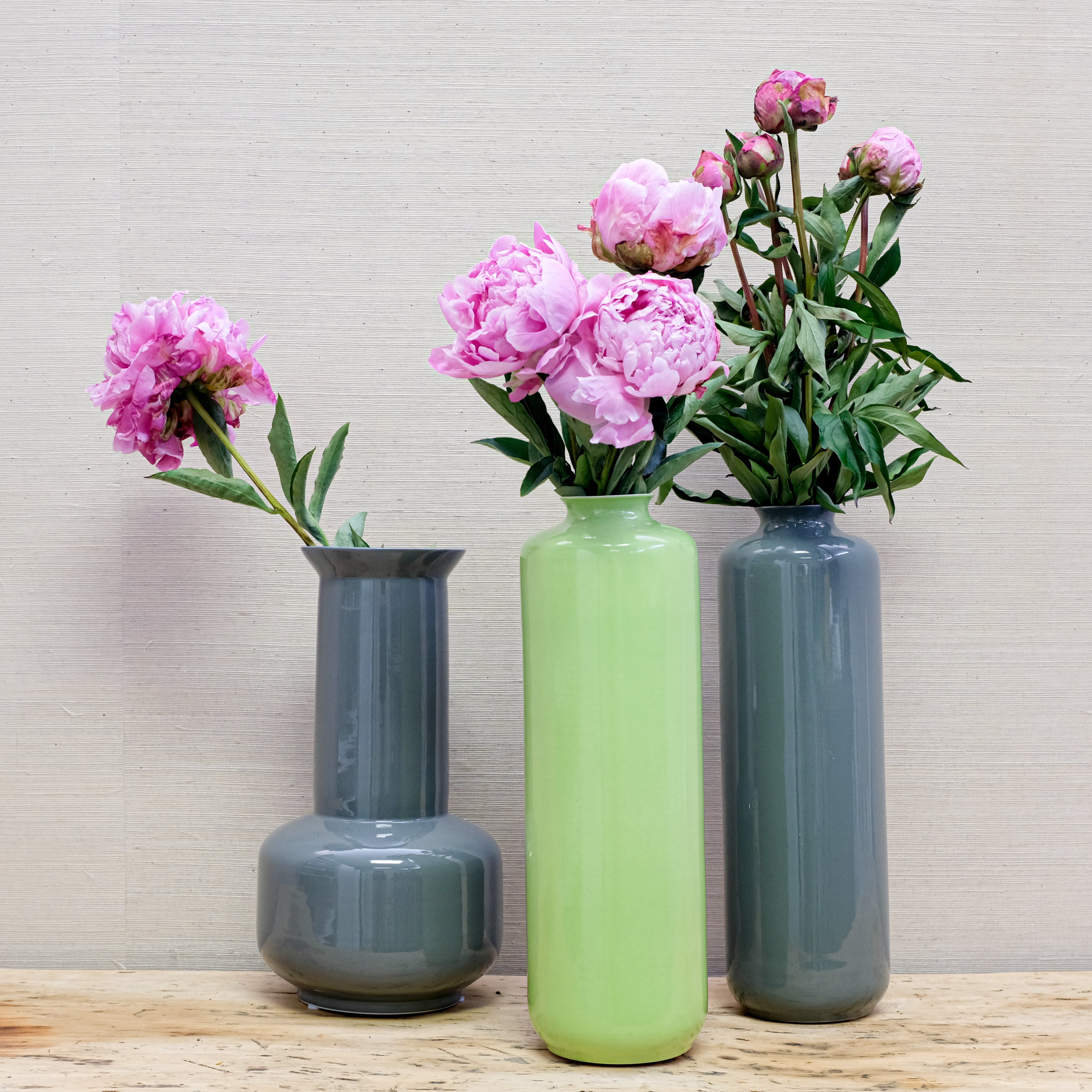 a trio of glossy-finish vases with peonies
