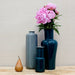 glossy grey and dark green vases shown with peonies